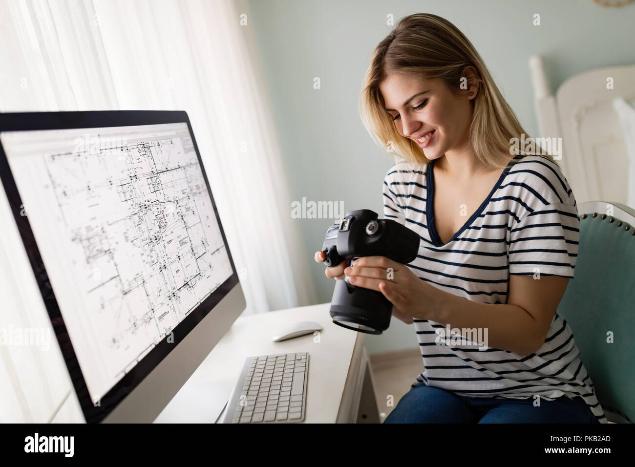 Portrait of young woman designing at home Stock Photo