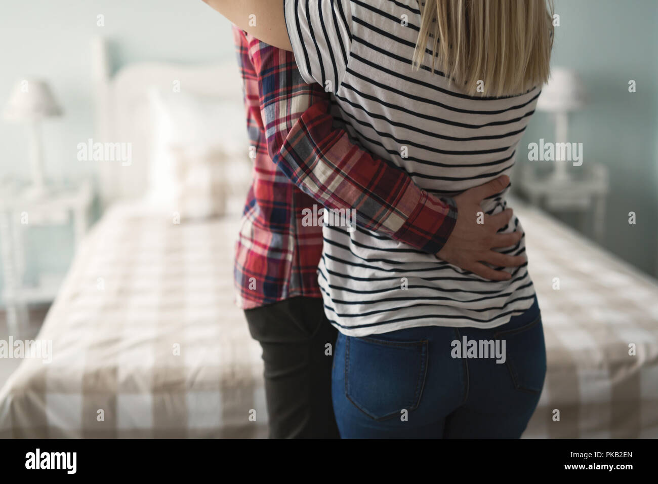 Portrait of romantic couple hugging in bedroom Stock Photo