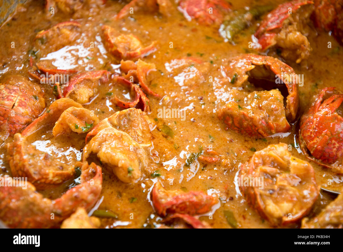A close up of a spicy seafood or crayfish curry to be served with authentic Indian rice, The crayfish boiled, de-veined and prepared as curry gravy Stock Photo
