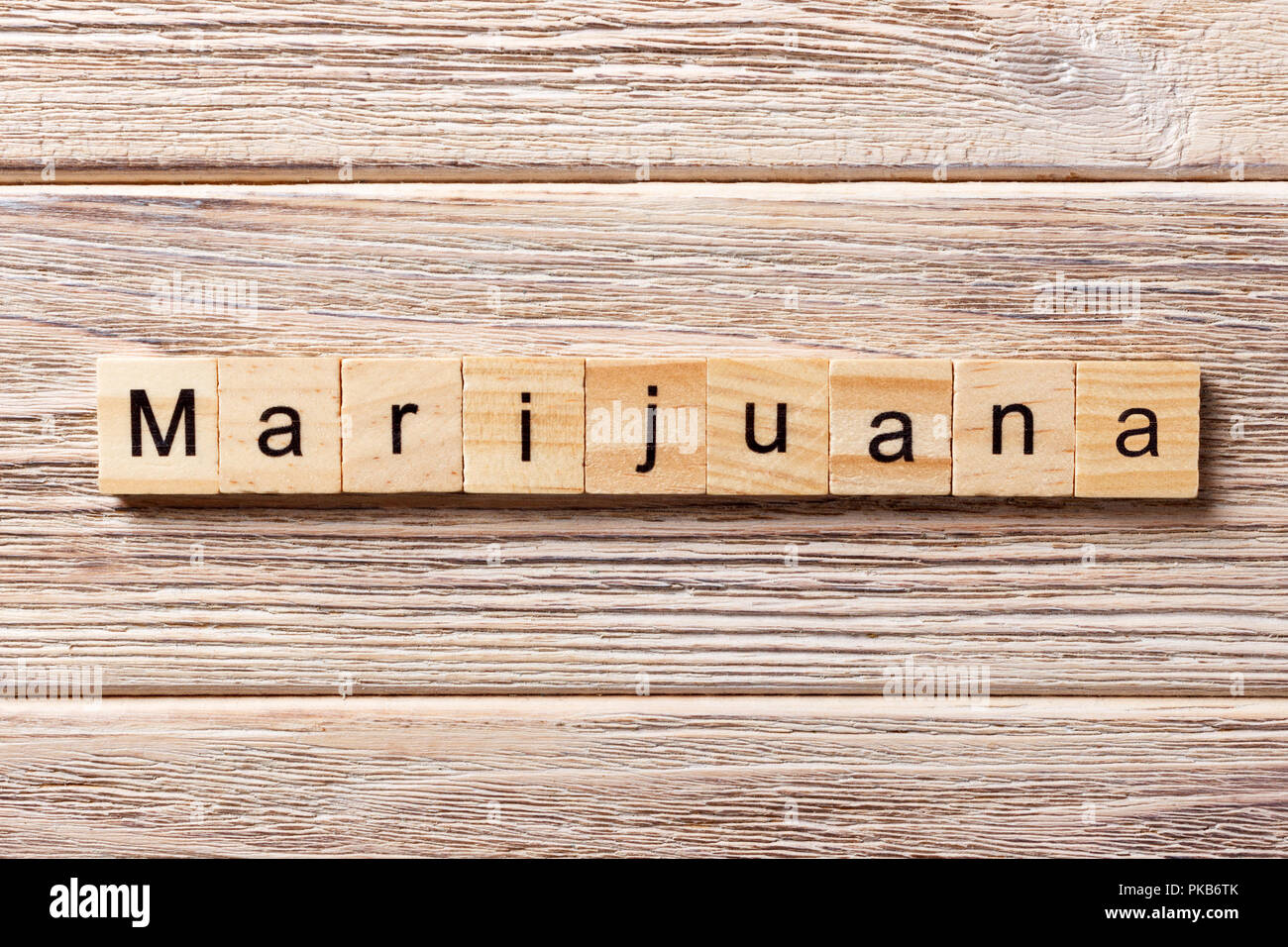 Marijuana word written on wood block. Marijuana text on table, concept. Stock Photo