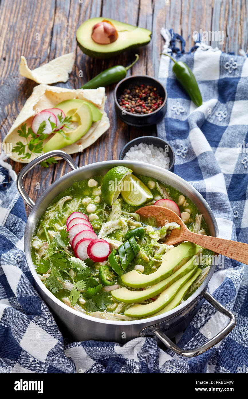 Chicken Pozole Verde in a pot Mexican stew filled with shredded