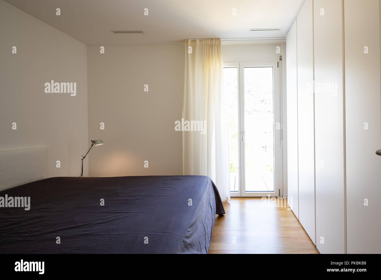 bedroom with a large window Stock Photo - Alamy