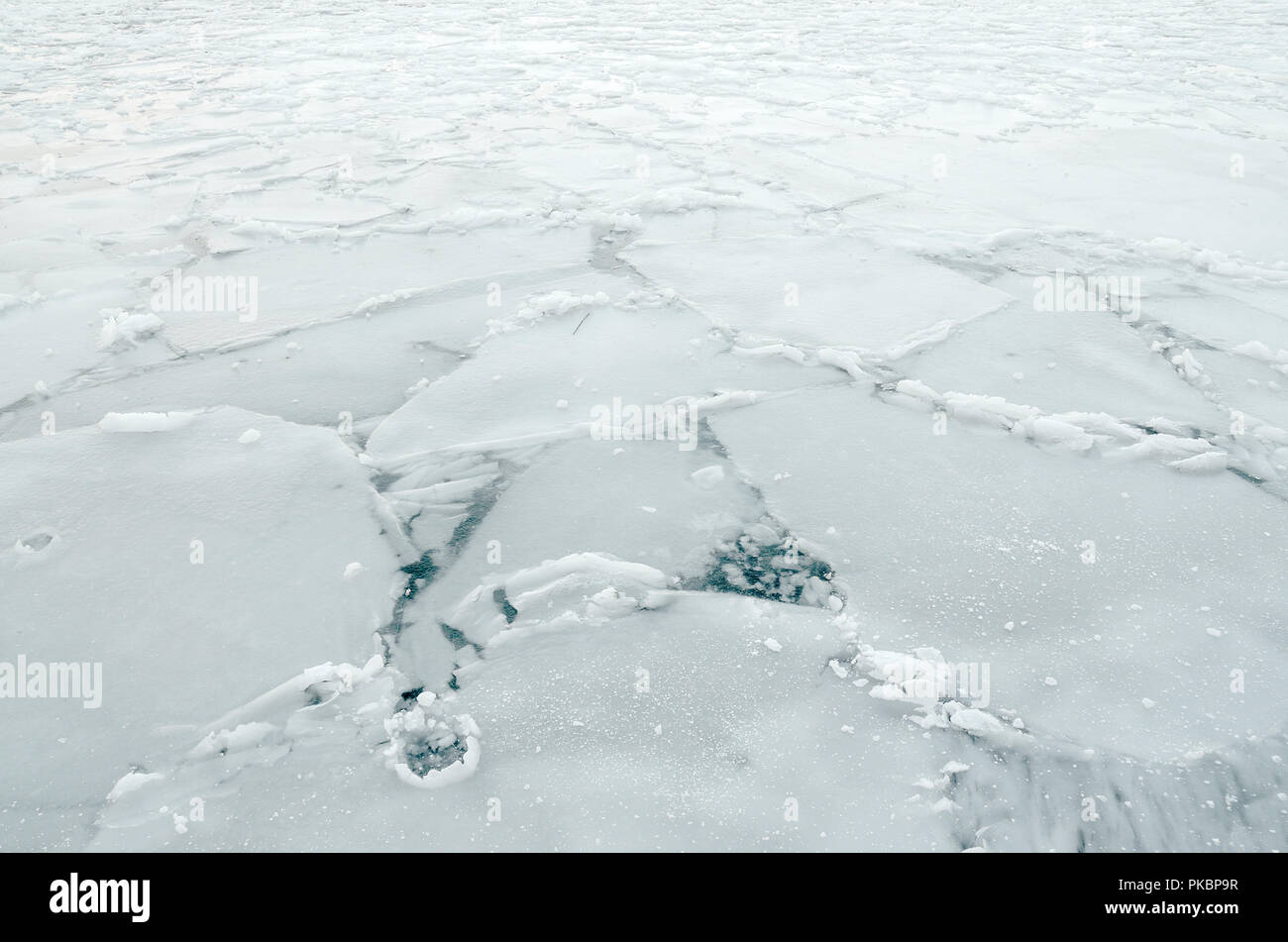 Surface of a frozen lake with huge chunks of ice Stock Photo - Alamy