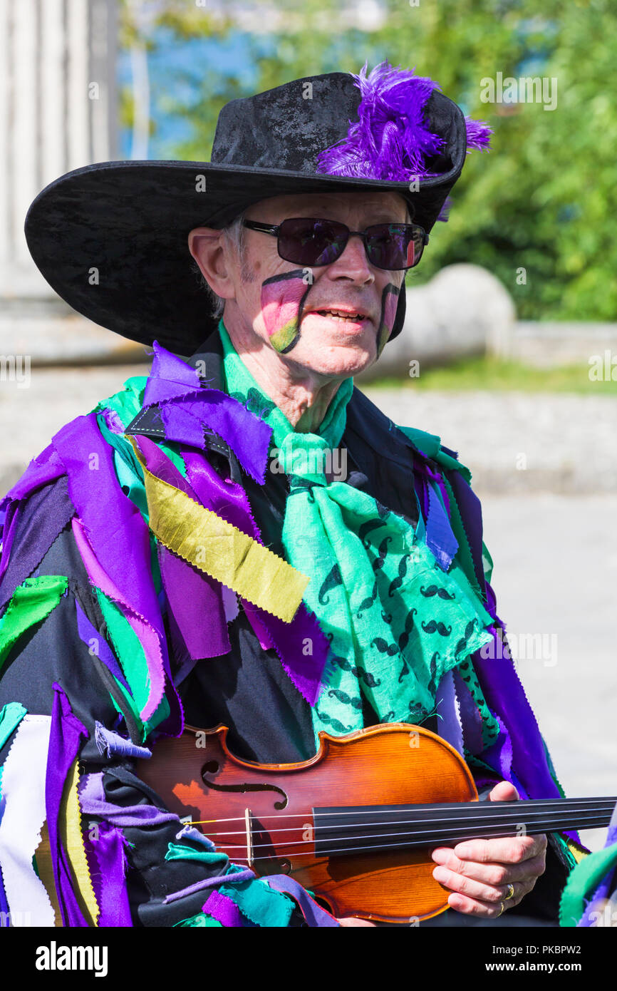 Morris dancer violin player member of Wicket Brood Border Morris at the Swanage Folk Festival, Swanage, Dorset UK on a warm sunny day in September Stock Photo