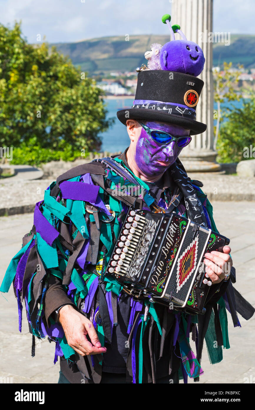Morris dancer musician playing accordion, member of Wicket Brood Border Morris at the Swanage Folk Festival, Swanage, Dorset UK on a warm sunny day Stock Photo