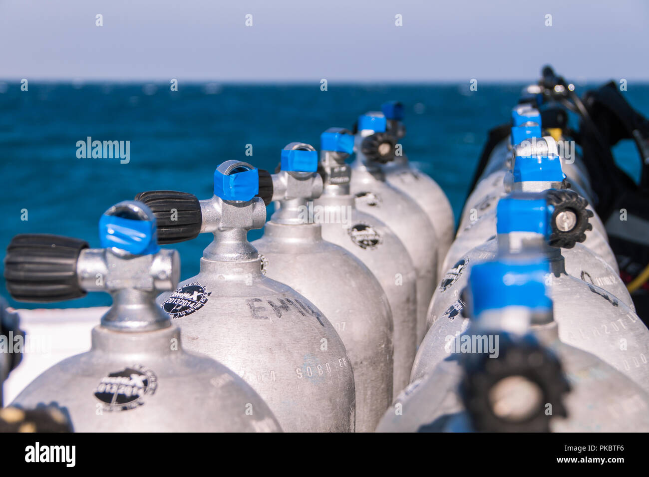 Scuba Diving Tanks with Blue Tape and Sea in the Background Stock Photo