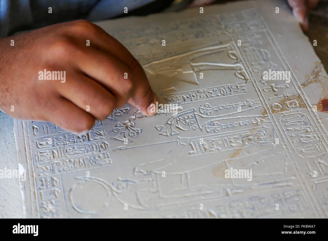 An skilled craftsman carving a limestone plaque at an Alabaster factory and shop in Egypt, Africa Stock Photo