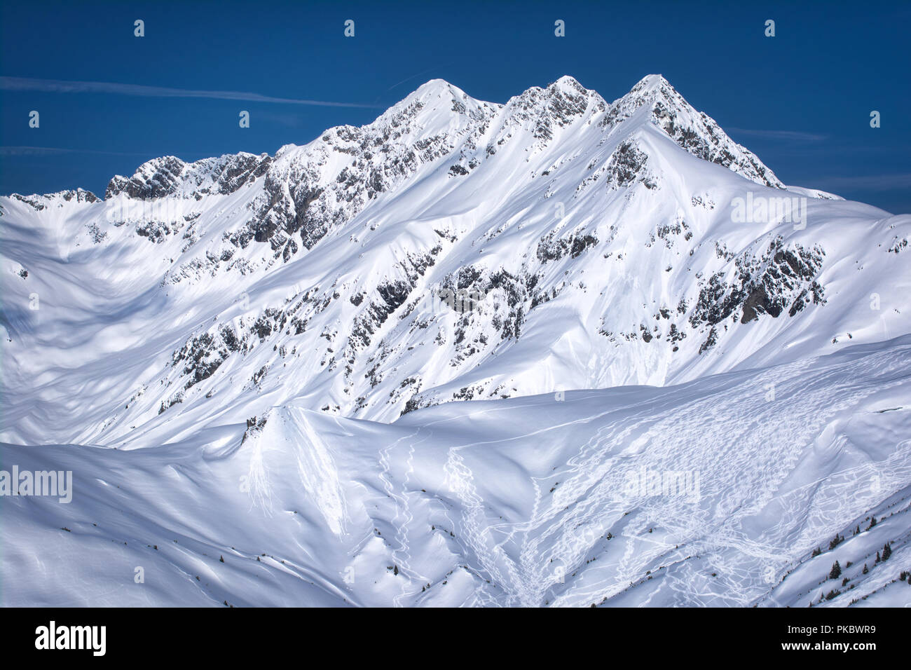 Austrian Mountain top. Snowy and lots of detailed ski tracks Stock Photo