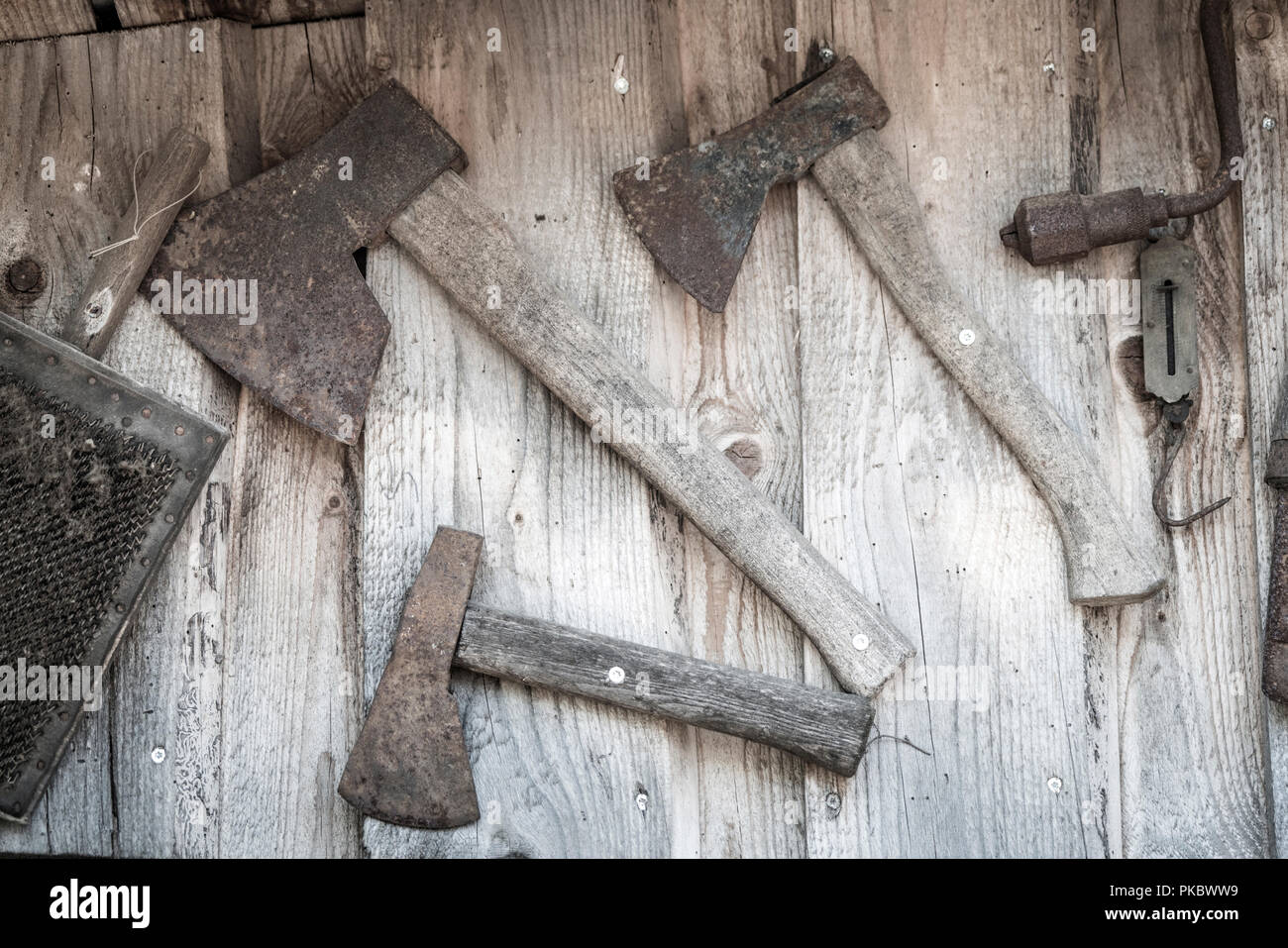 Old axes hanging on a wall in a wooden cabin Stock Photo Alamy