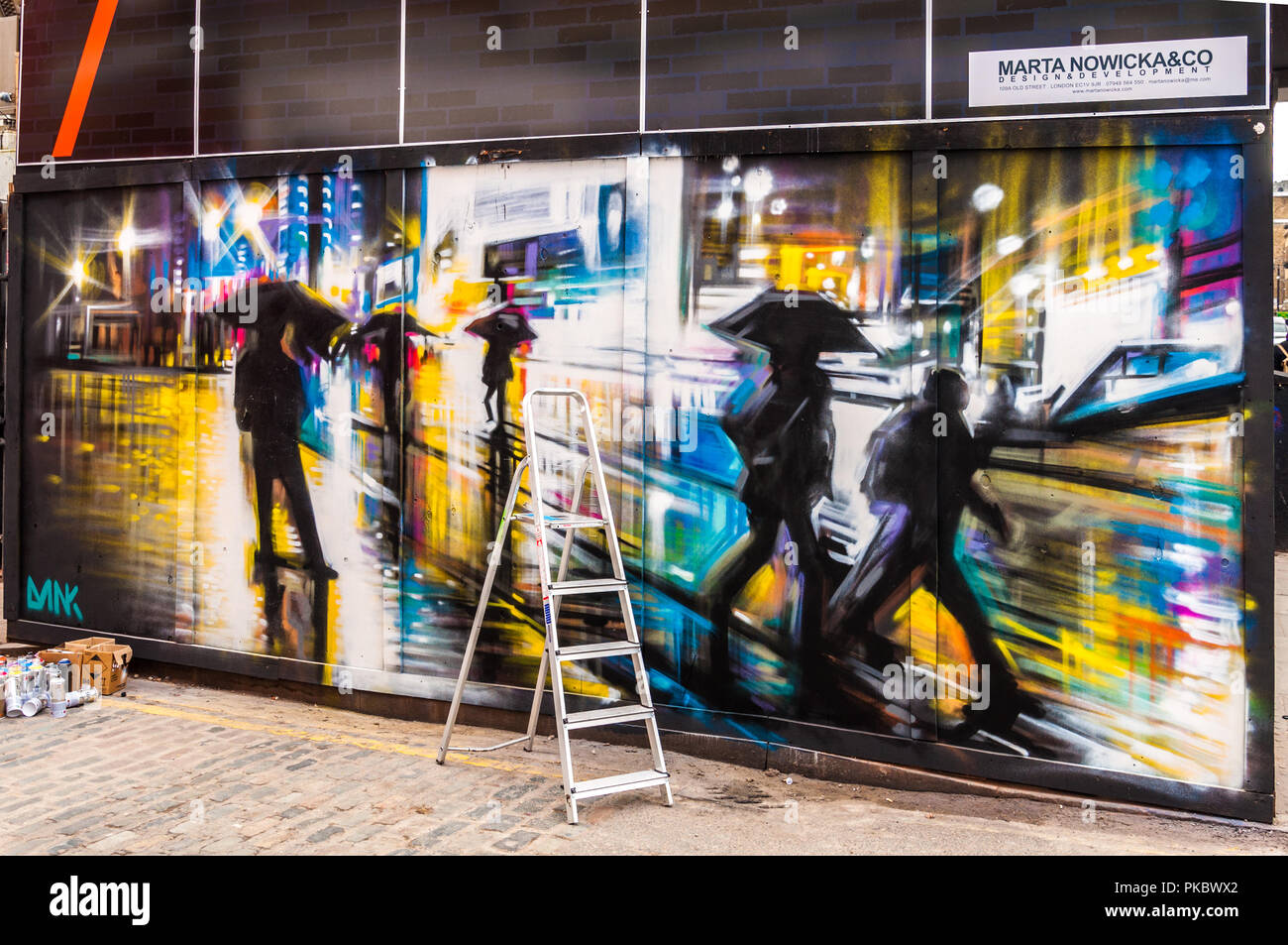 A colourful graffiti rainy night time street scene in Spitalfields, London, England, UK Stock Photo