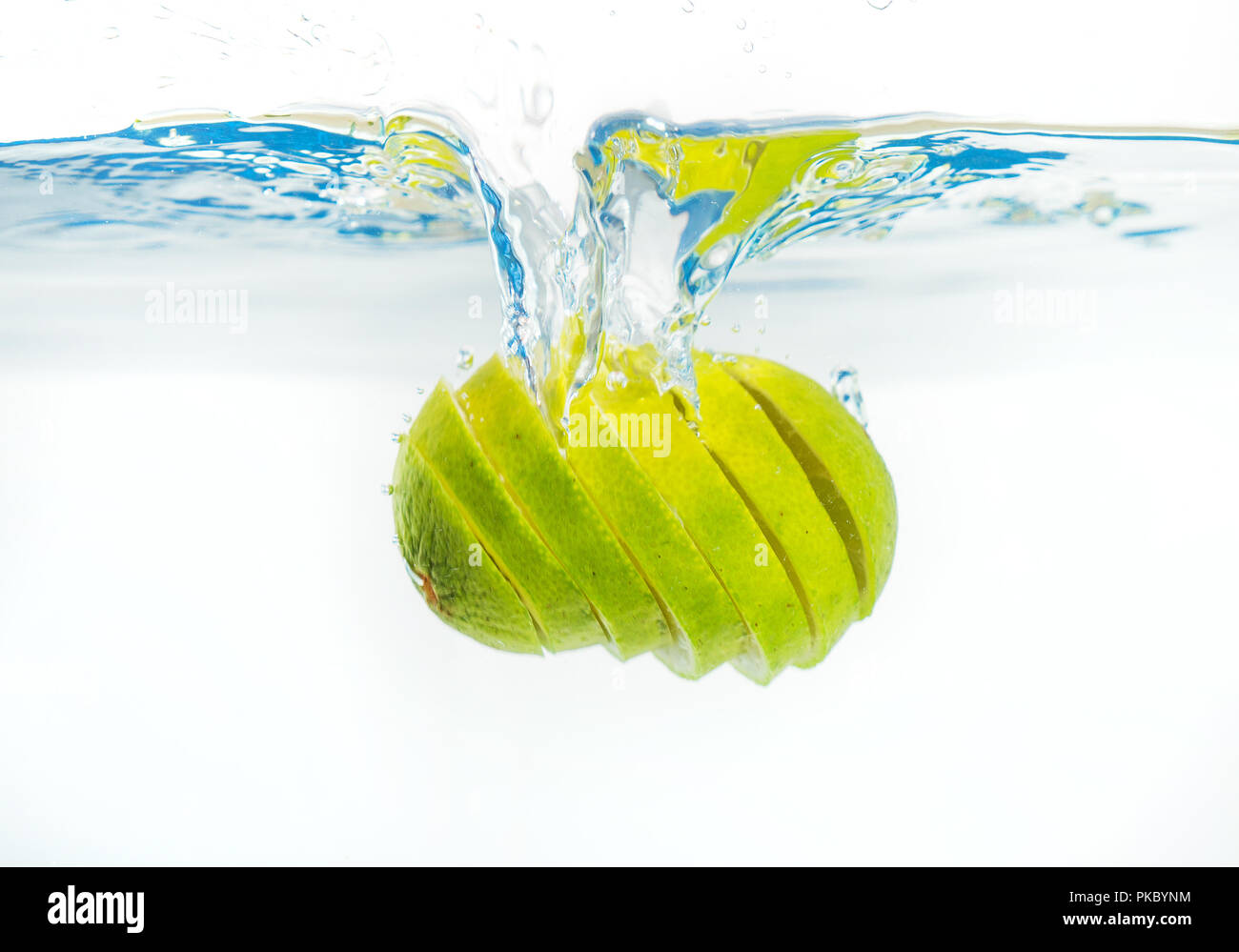 Fresh lime falling into the water. Suitable for advertisement. Stock Photo