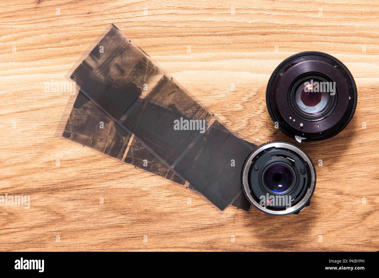 Old camera lenses and negative film Stock Photo Alamy
