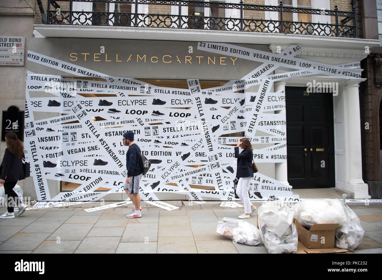 Old Bond Street, London, UK. 12 September, 2018. Vegan leather Adidas  sneakers window wrapping covers the frontage of 23 Old Bond Street  promoting the iconic Stan Smith shoes, available worldwide from September