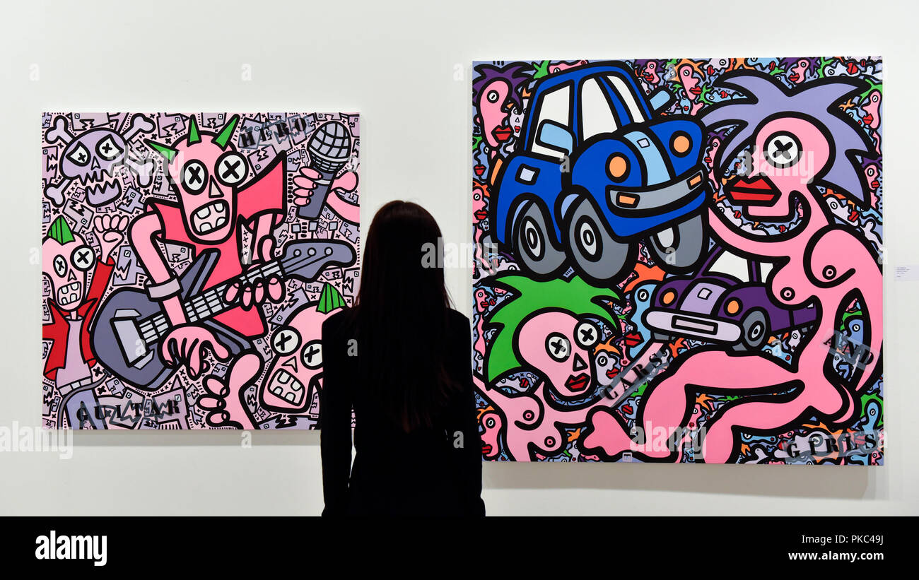 London, UK.  12 September 2018. A staff member views (L to R) 'Guitar Hero' and 'Cars and Girls' by Yann Sciberras (France) at the preview of START, a contemporary art fair comprising eclectic works from a variety of international emerging artists.  The fair takes place at the Saatchi Gallery in Chelsea 13 to 16 September 2018.   Credit: Stephen Chung / Alamy Live News Stock Photo