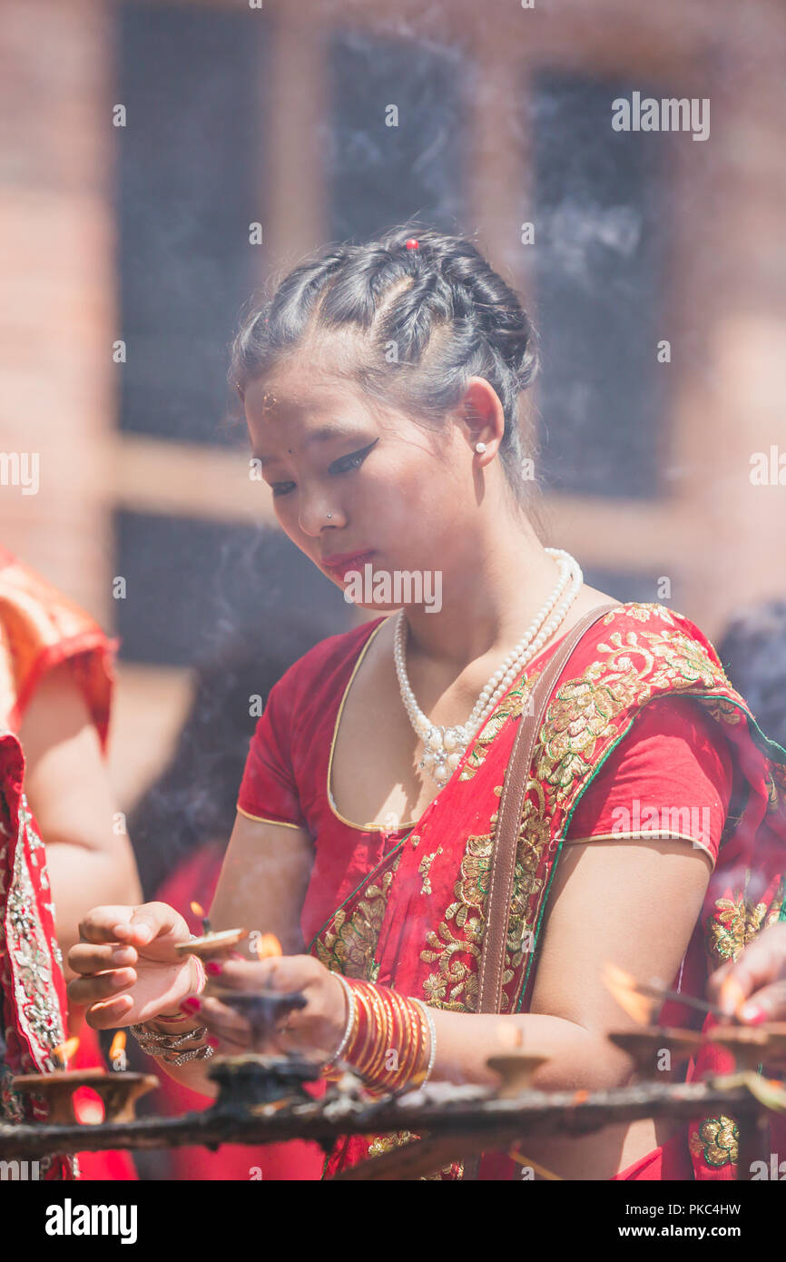 Kathmandu,Nepal - Sep 12,2018: Hindu Nepali Women offering prayers with lighing lamp in the Temple at Teej Festival in Kathmandu.Hindu Nepali Women fast and wish for a prosperous life of their spouse and family on this festival.The festivals for women, include dancing, singing, getting together with friends,, wearing red, green or orange clothes, sharing festive foods Credit: Nabaraj Regmi/Alamy Live News Stock Photo