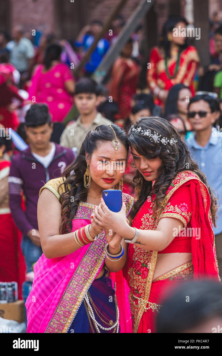 Kathmandu,Nepal - Sep 12,2018: Nepali Women watching photo after take selfies with Smartphone at Teej Festival in Kathmandu.Hindu Nepali Women fast and wish for a prosperous life of their spouse and family on this festival.The festivals for women, include dancing, singing, getting together with friends,, wearing red, green or orange clothes, sharing festive foods Credit: Nabaraj Regmi/Alamy Live News Stock Photo