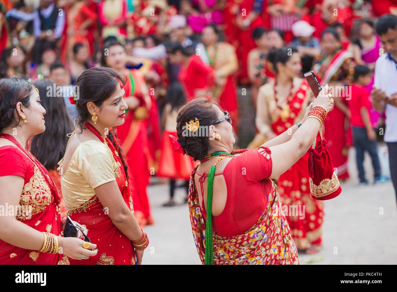 Kathmandu,Nepal - Sep 12,2018: Nepali Women take selfies with Smartphone at Teej Festival in Kathmandu.Hindu Nepali Women fast and wish for a prosperous life of their spouse and family on this festival.The festivals for women, include dancing, singing, getting together with friends,, wearing red, green or orange clothes, sharing festive foods Credit: Nabaraj Regmi/Alamy Live News Stock Photo