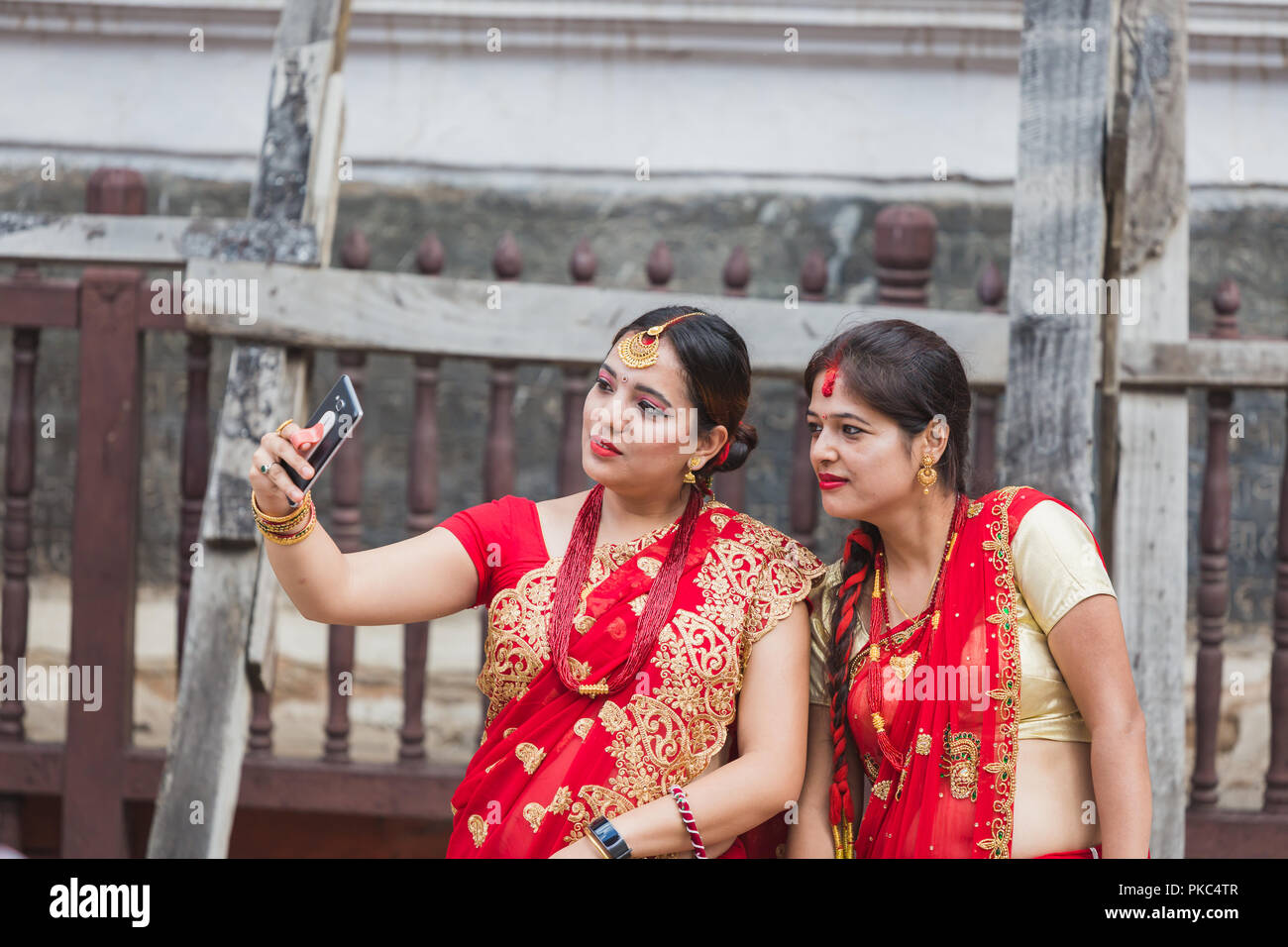Kathmandu,Nepal - Sep 12,2018: Nepali Women take selfies with Smartphone at Teej Festival in Kathmandu.Hindu Nepali Women fast and wish for a prosperous life of their spouse and family on this festival.The festivals for women, include dancing, singing, getting together with friends,, wearing red, green or orange clothes, sharing festive foods Credit: Nabaraj Regmi/Alamy Live News Stock Photo