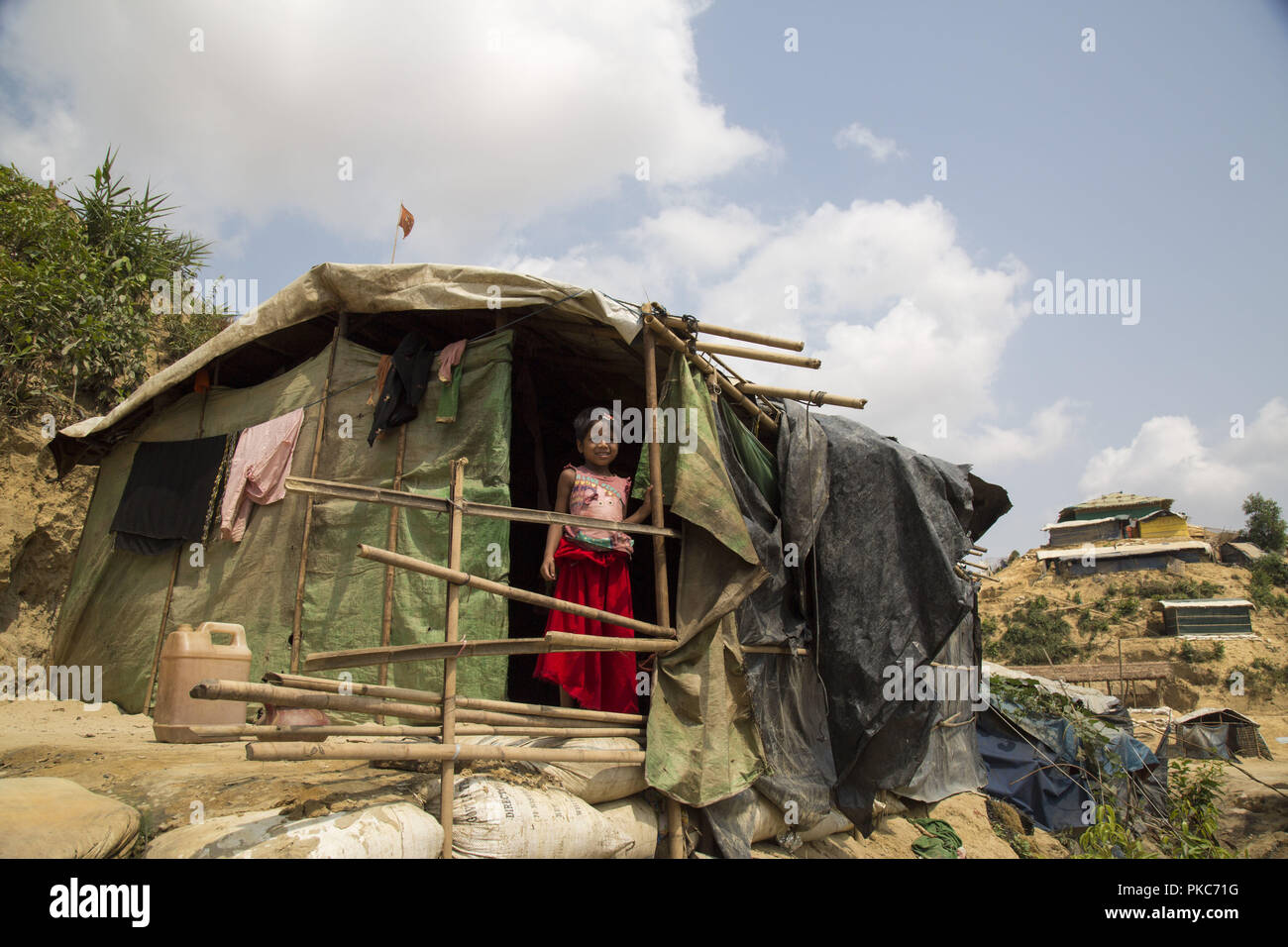 May 18, 2018 - Cox's Bazar, Bangladesh - A Rohingya refugee girl stands inside a shelter at a refugee camp in Cox's Bazar. In the Rohingya refugee camps of southern Bangladesh, where flimsy bamboo shelters sprawl across the steep hillsides and flood prone valleys, there has been a desperate effort to get ready for the coming cyclone and monsoon season. Credit: Zakir Hossain Chowdhury/ZUMA Wire/Alamy Live News Stock Photo