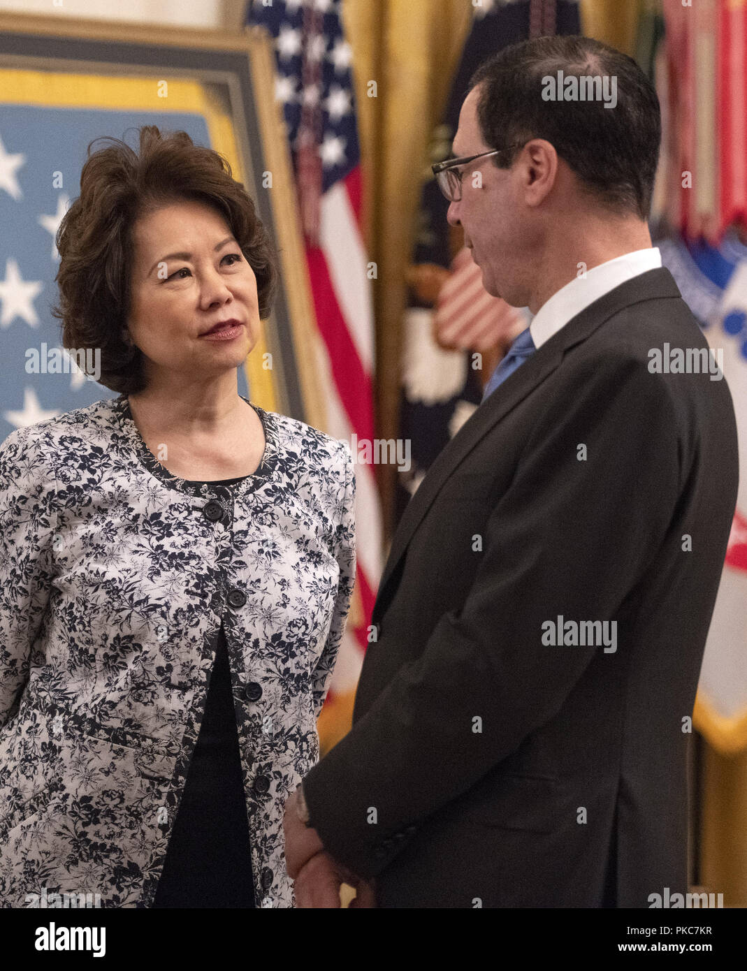 Washington, District of Columbia, USA. 12th Sep, 2018. United States Secretary of Transportation Elaine Chao, left, in conversation with US Secretary of the Treasury Steven Mnuchin, right, prior to the arrival of US President Donald J. Trump who will make remarks at the Congressional Medal of Honor Society Reception in the East Room of the White House in Washington, DC on Wednesday, September 12, 2018 Credit: Ron Sachs/CNP/ZUMA Wire/Alamy Live News Stock Photo