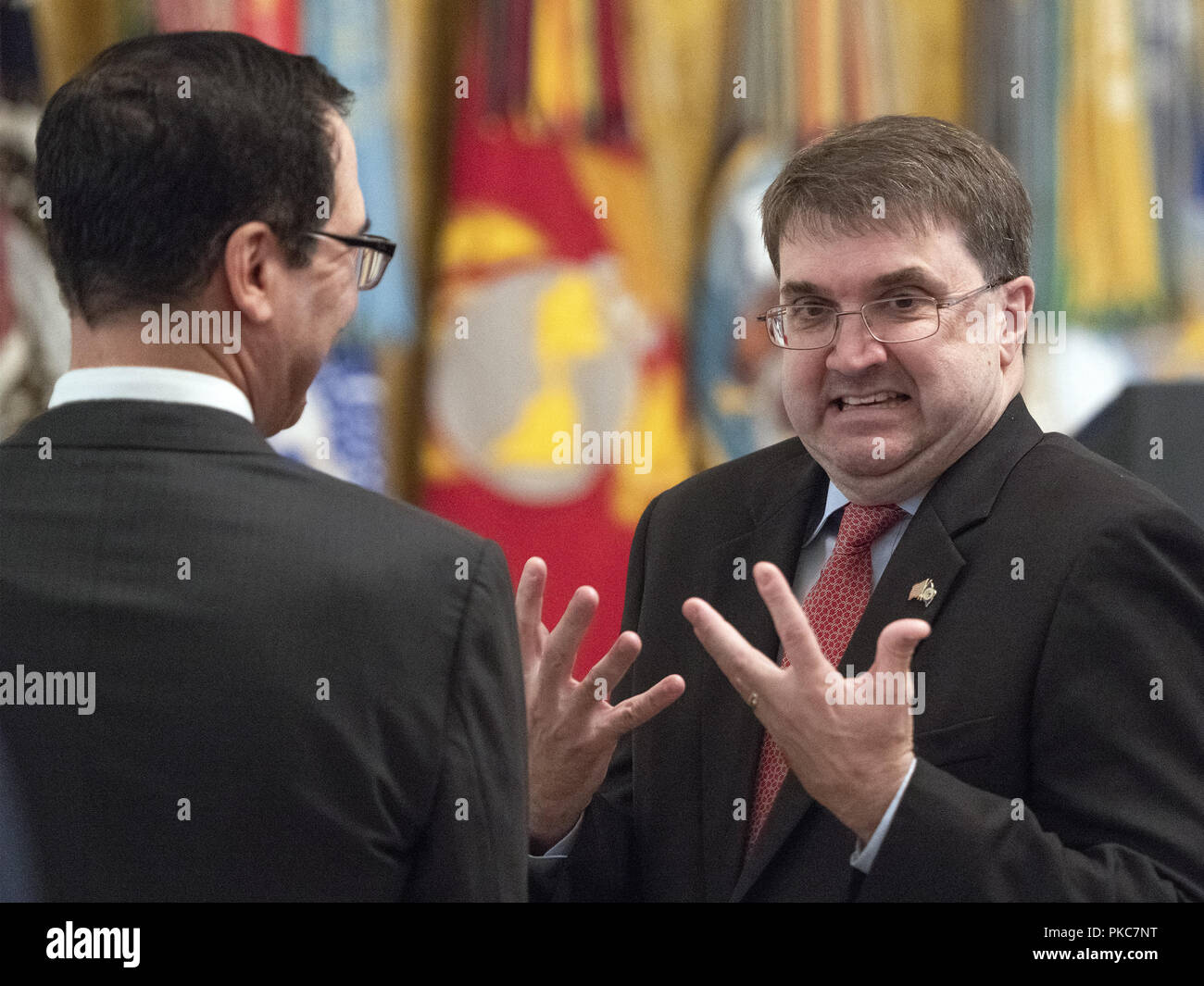 Washington, District of Columbia, USA. 12th Sep, 2018. United States Secretary of Veterans Affairs Robert Wilkie, right, in conversation with US Secretary of the Treasury Steven Mnuchin, left, prior to the arrival of US President Donald J. Trump who will make remarks at the Congressional Medal of Honor Society Reception in the East Room of the White House in Washington, DC on Wednesday, September 12, 2018 Credit: Ron Sachs/CNP/ZUMA Wire/Alamy Live News Stock Photo