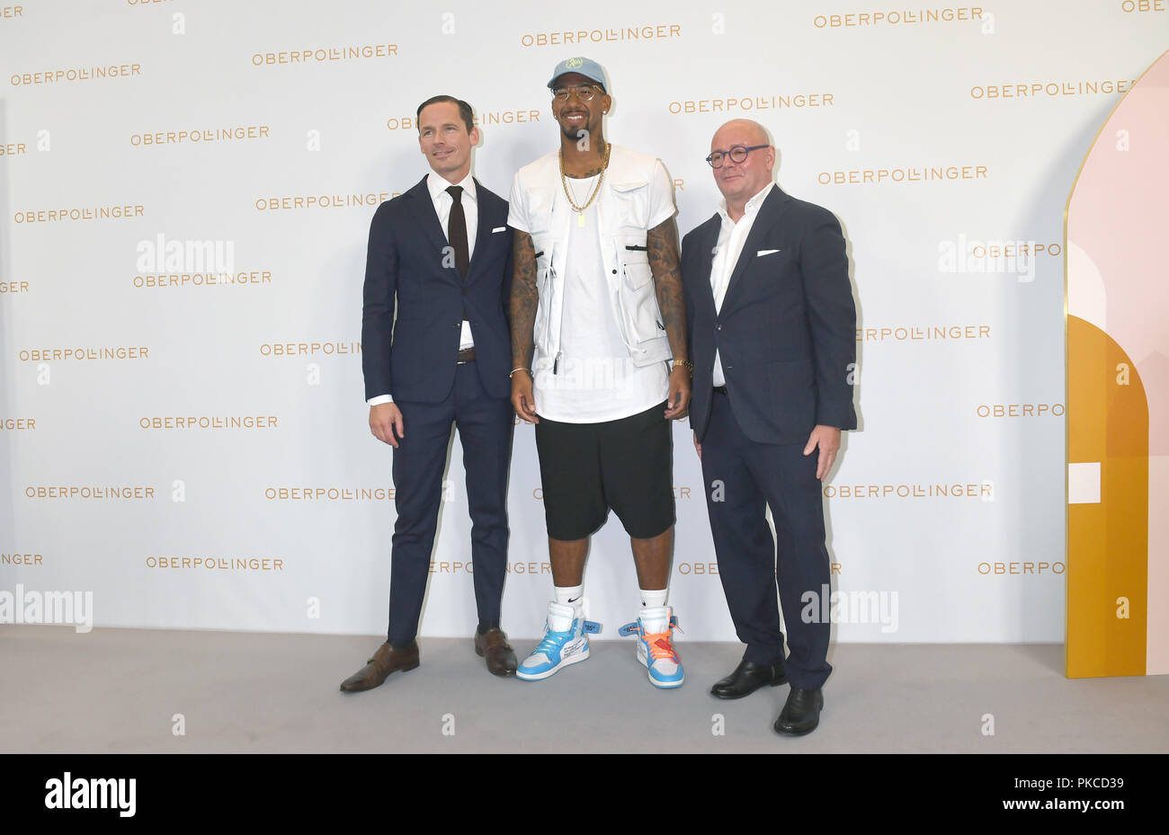 Munich, Bavaria. 12th Sep, 2018. Alexander Repp (l-r), Managing Director at Oberpollinger, footballer Jerome Boateng and André Maeder, Managing Director of the KaDeWe Group, can be seen at the grand opening of Munich's new magnificent mile in Oberpollinger. Credit: Felix Hörhager/dpa/Alamy Live News Stock Photo