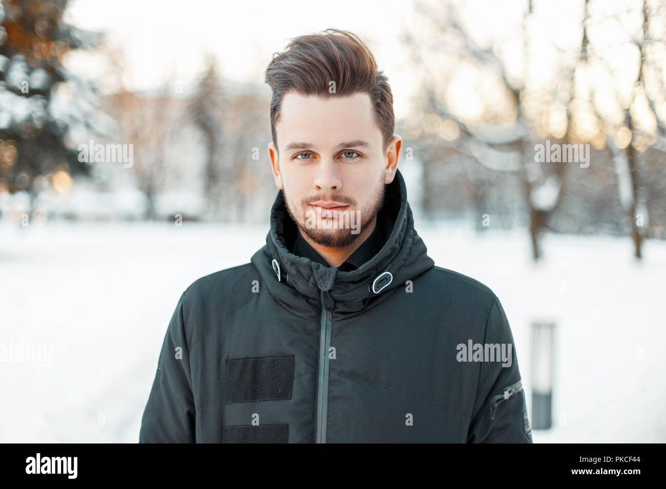 Handsome man with a beard and hairstyle in winter jacket in the park Stock Photo - Alamy Handsome man with a beard and hairstyle in winter jacket in the park Stock Photo - Alamy