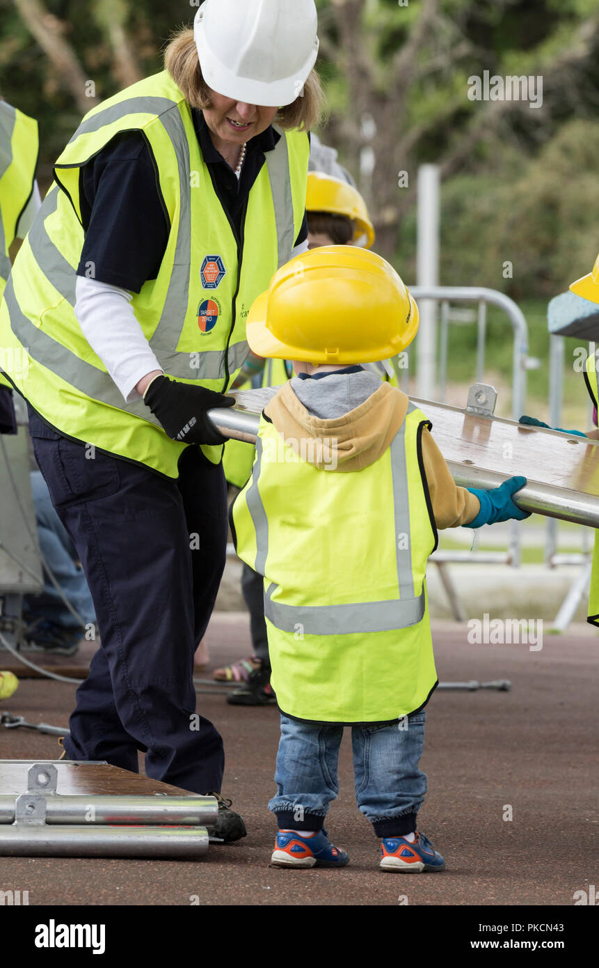 Children helping to build bridge at Institute of Civil Engineers stand at Riveting Stuff festival UK Stock Photo