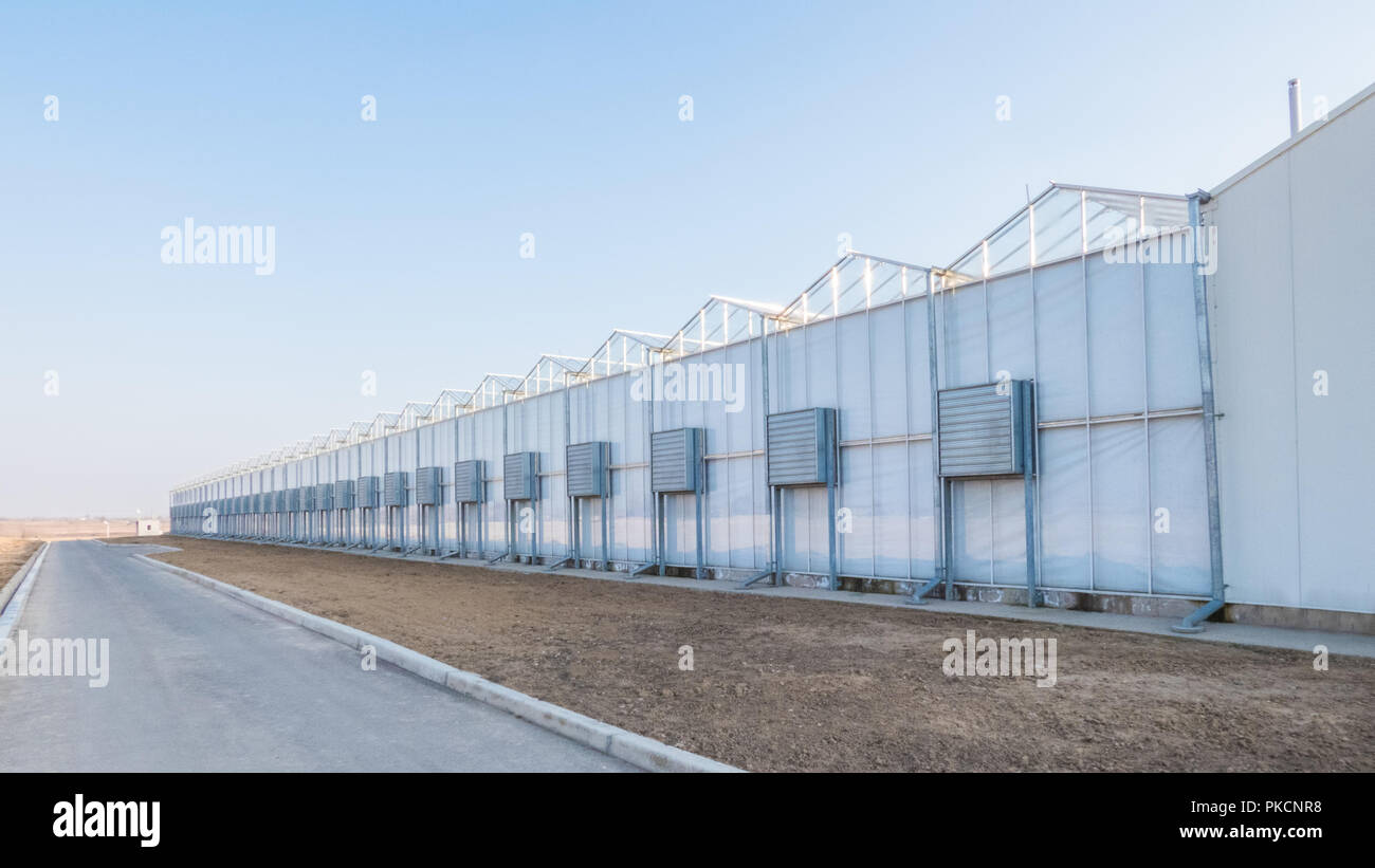greenhouse facade with air conditioning and air ducts outside Stock