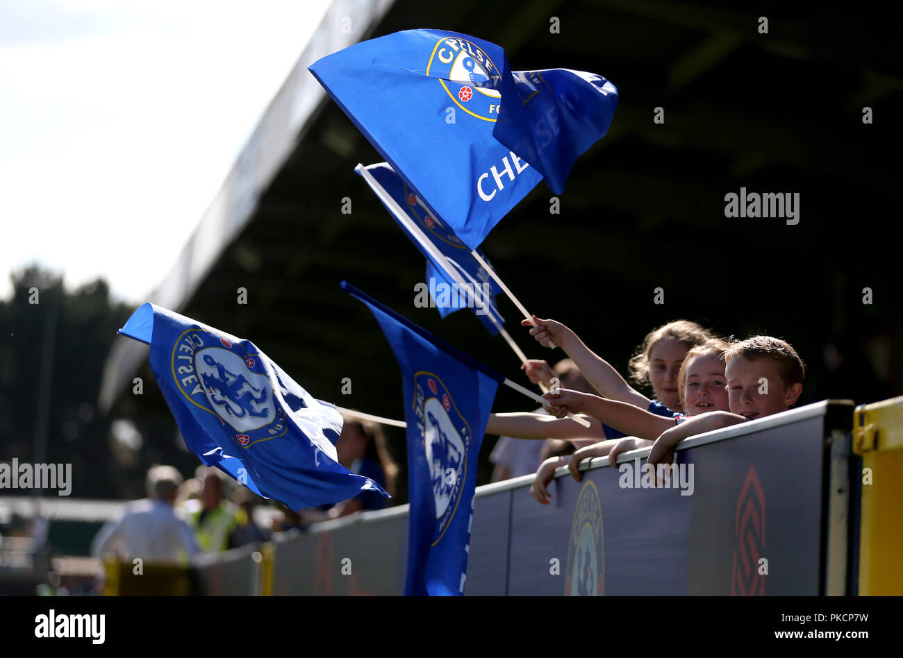 Chelsea fans wave flags in the stands hires stock photography and