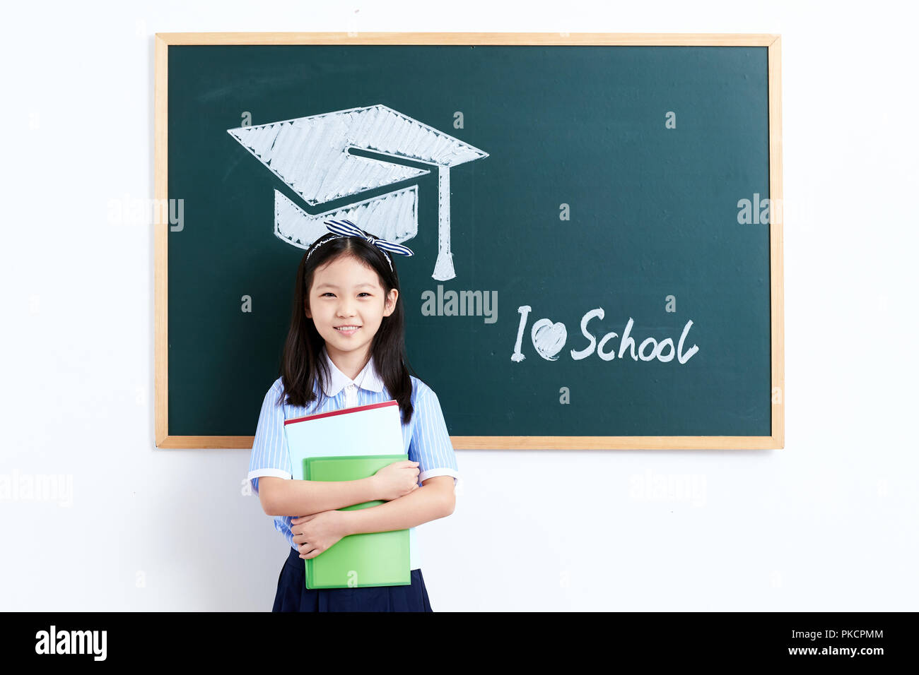 Primary school women standing in front of the blackboard Stock Photo