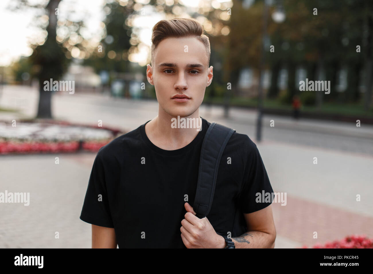 Handsome Young Man With A Haircut With A Backpack On The