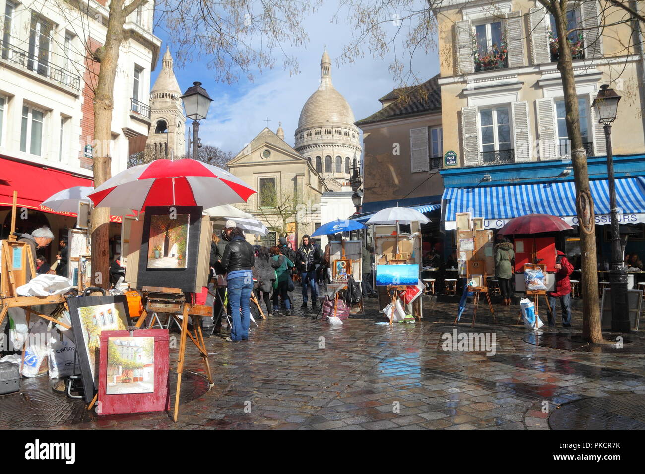 PARIS-MARCH 3: Artists artworks and easels set up in the charming Place du Tertre in Montmartre, Paris on March 3, 2014. Montmartre is one of the most Stock Photo