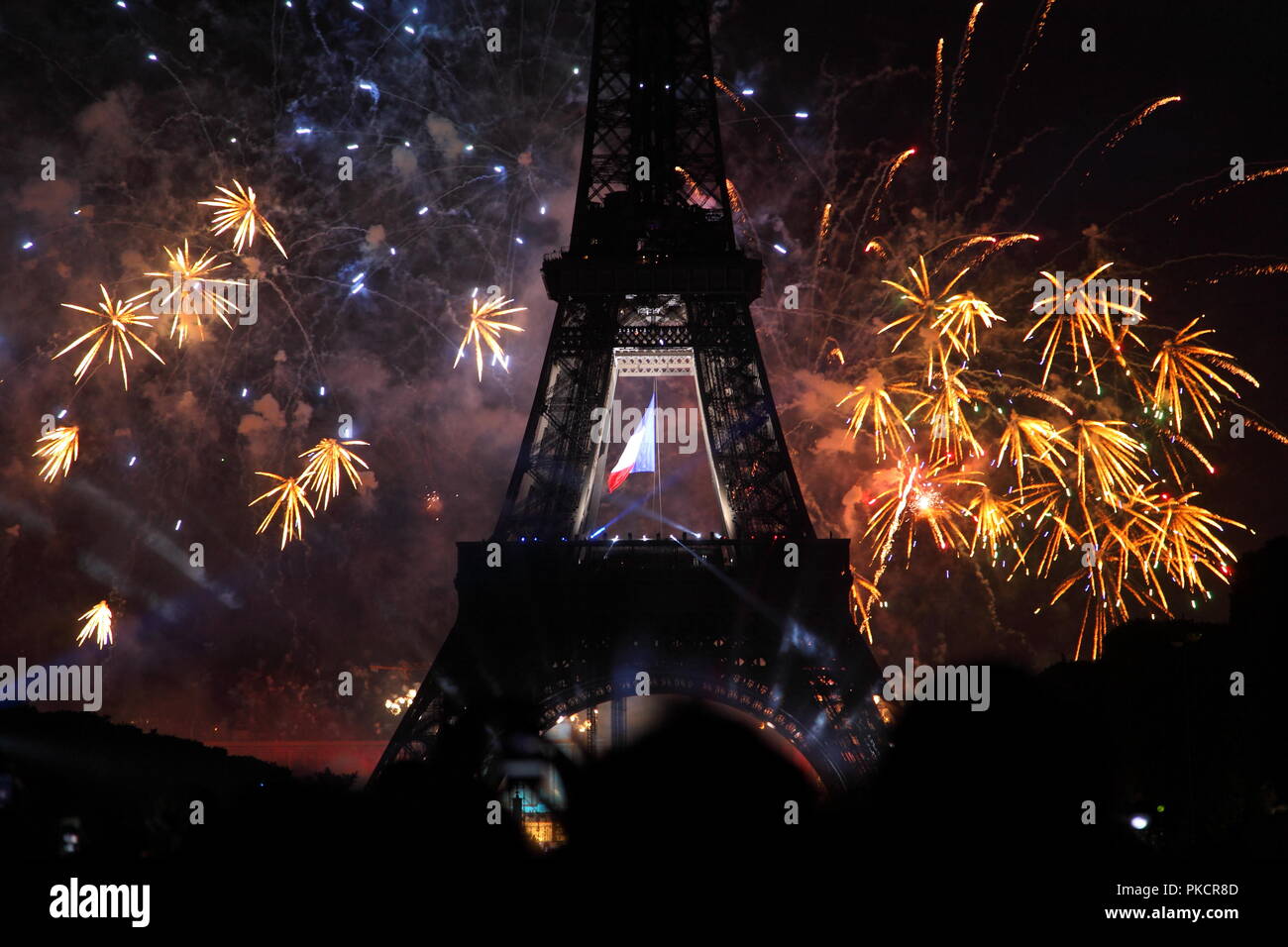 Famous fireworks near Eiffel Tower during celebrations of french national holiday, Bastille Day, in Paris, France. Stock Photo