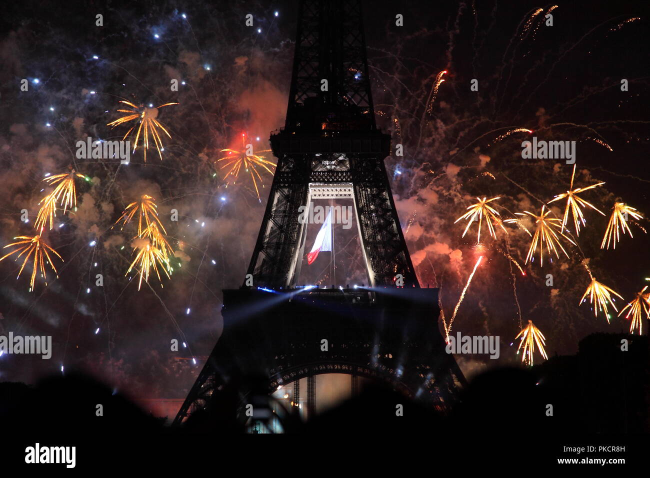 Famous fireworks near Eiffel Tower during celebrations of french national holiday, Bastille Day, in Paris, France. Stock Photo