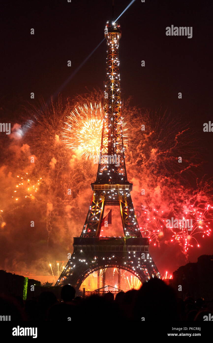 Famous fireworks near Eiffel Tower during celebrations of french national holiday, Bastille Day, in Paris, France. Stock Photo