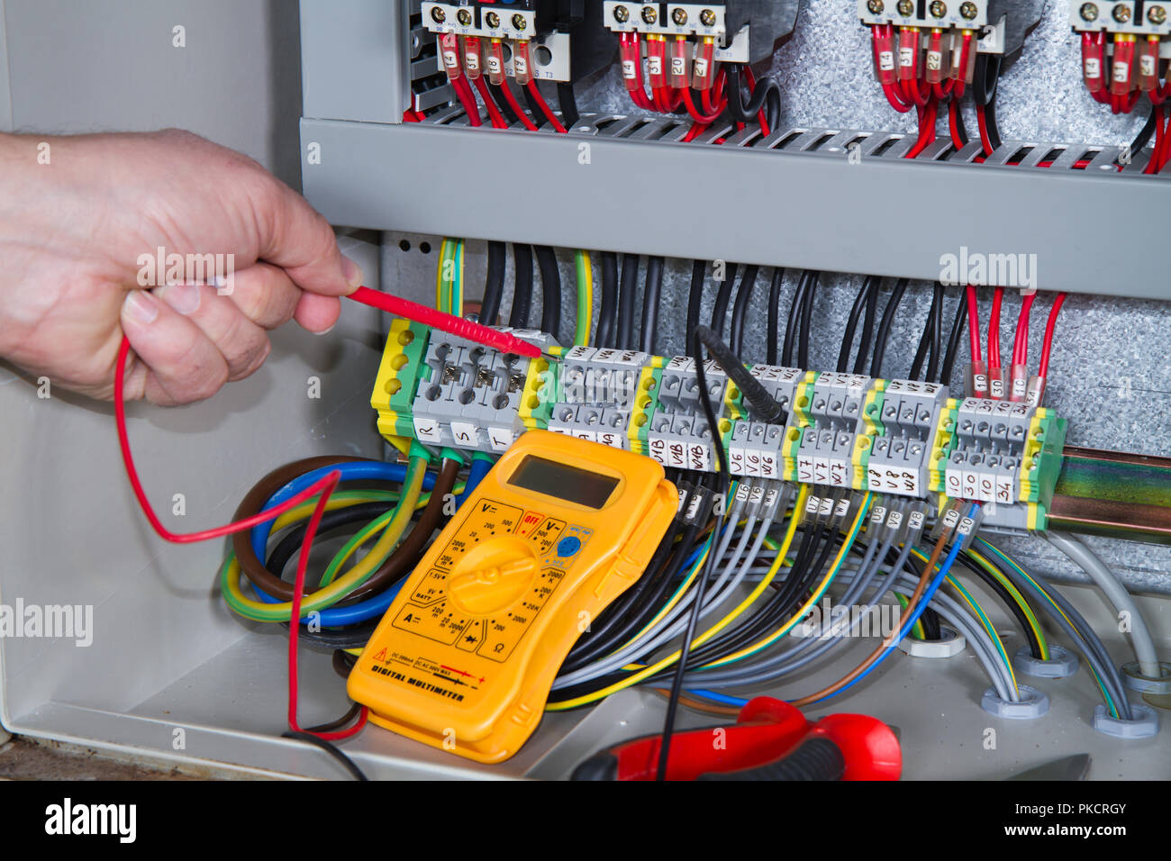electrician at work with an electric panel Stock Photo