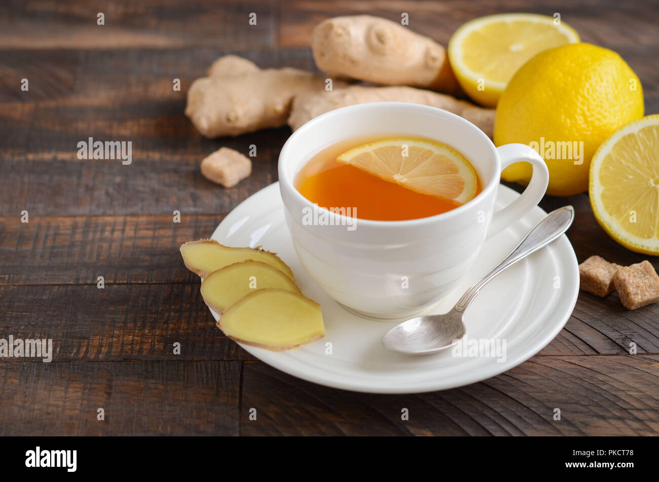 Ginger root tea with lemon and honey on wooden background. Stock Photo