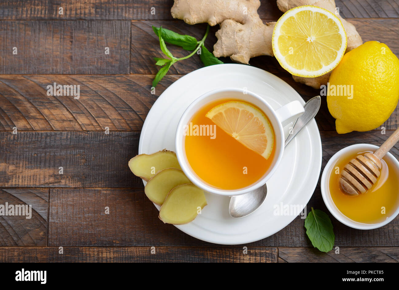 Ginger root tea with lemon and honey on wooden background. Stock Photo
