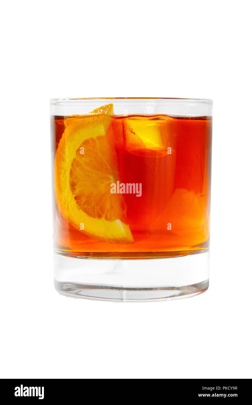 A single-colored transparent cocktail, refreshing in a low glass with radiant ice cubes with taste of berries, cola and slice, lemon, orange,. Side vi Stock Photo