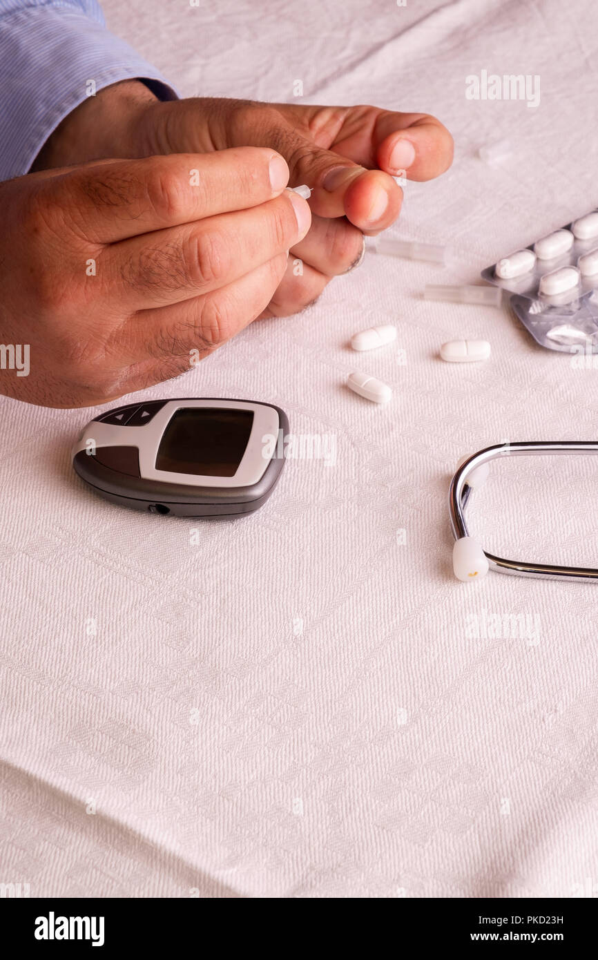 Man Using Glucometer man checking blood sugar by glucometer Stock Photo - Alamy