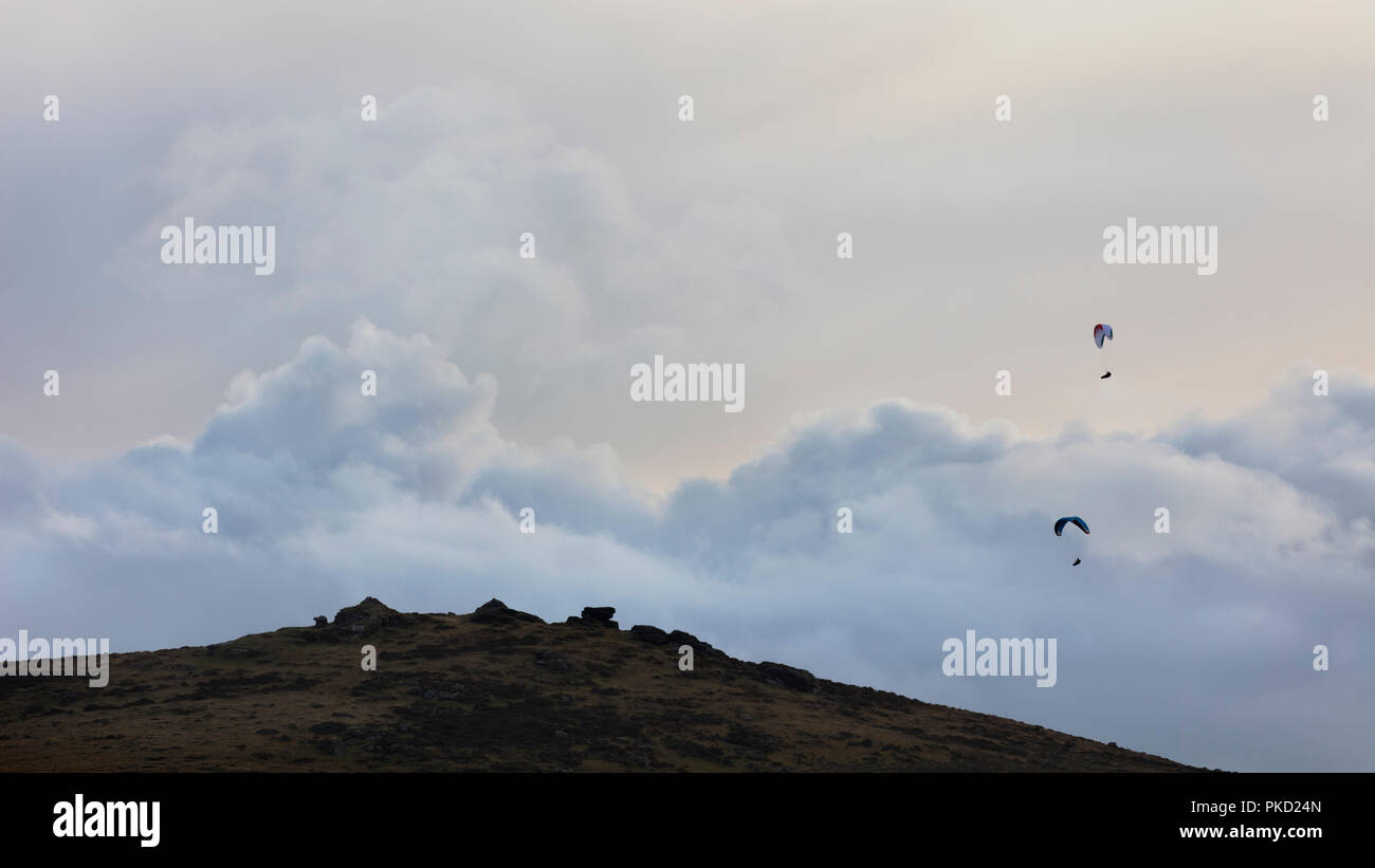 Two paragliders over Honeybags tor in Dartmoor National Park in Devon Stock Photo