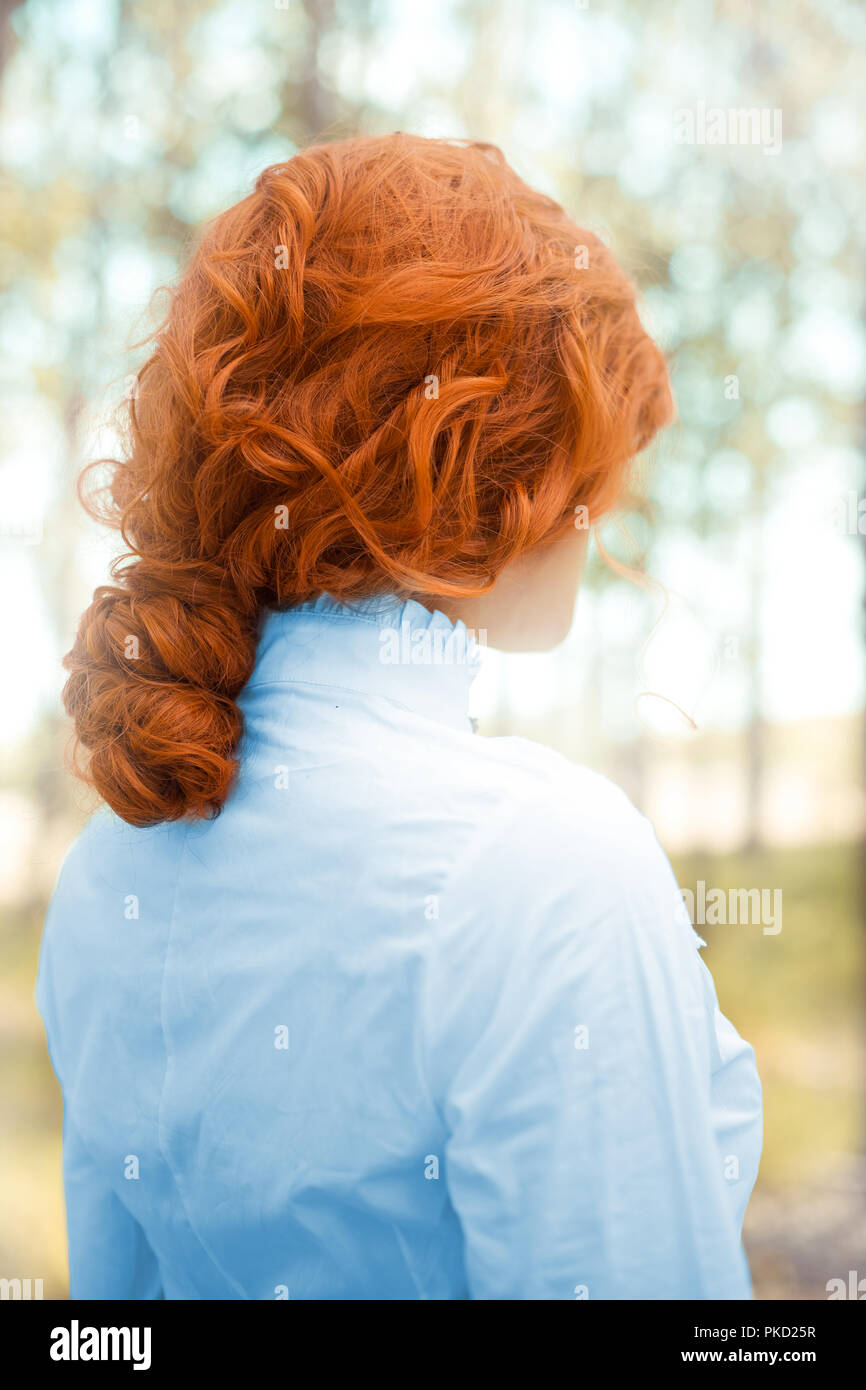 Victorian woman standing in forest Stock Photo