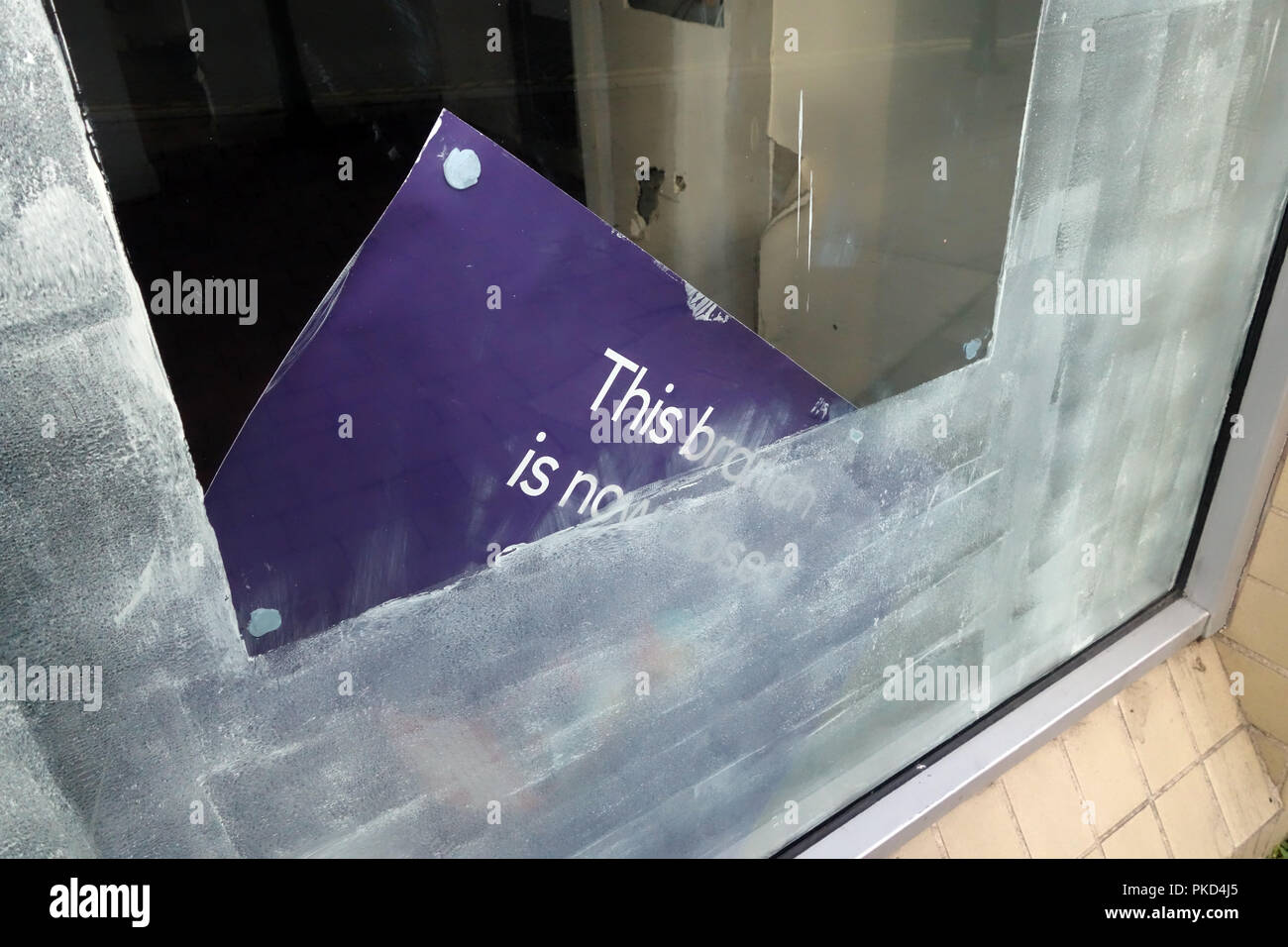 Closeup of Bank closure signs in ex bank window at a Nat West Bank