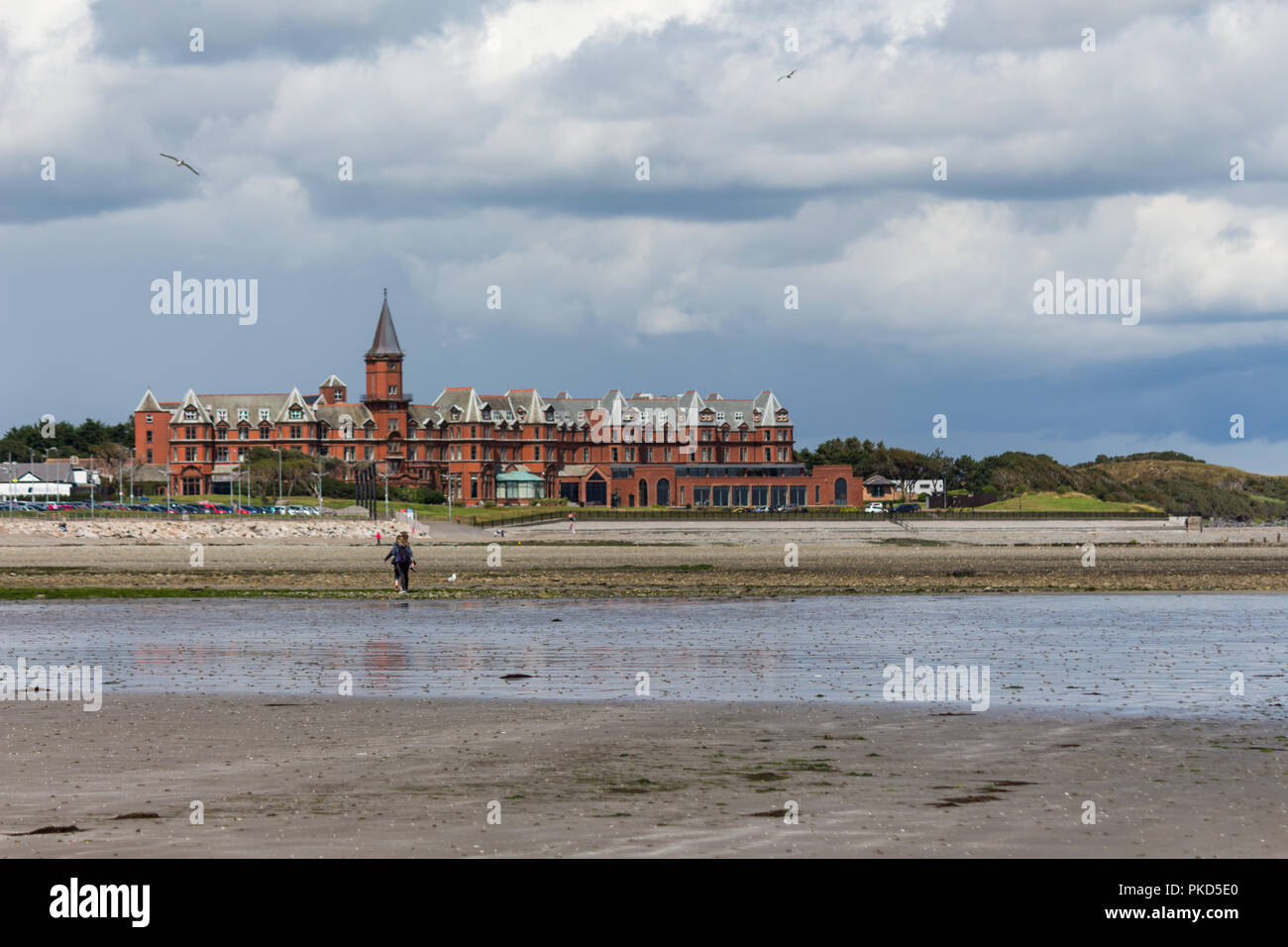 Newcastle beach at low tide with view to the Slieve Donard Hotel. Stock Photo