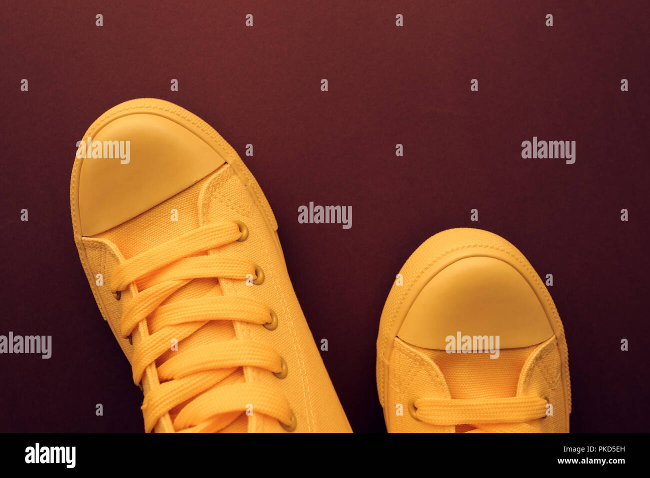 Stylish yellow sneakers from above, young person unisex style and fashion concept with copy space, top view Stock Photo
