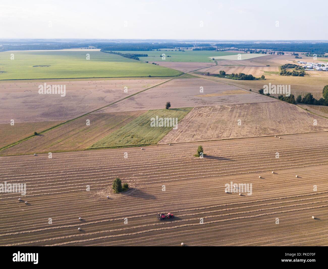 Aerial: stubble field with straw bales at late summer. Polish landscape ...
