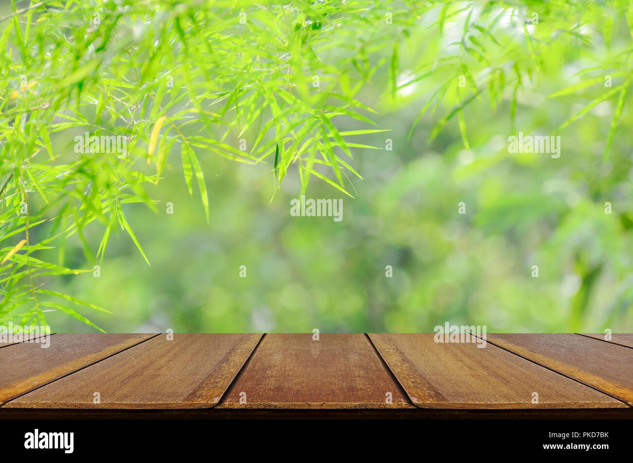 Empty wooden table over blurred bamboo forest with bokeh background ...