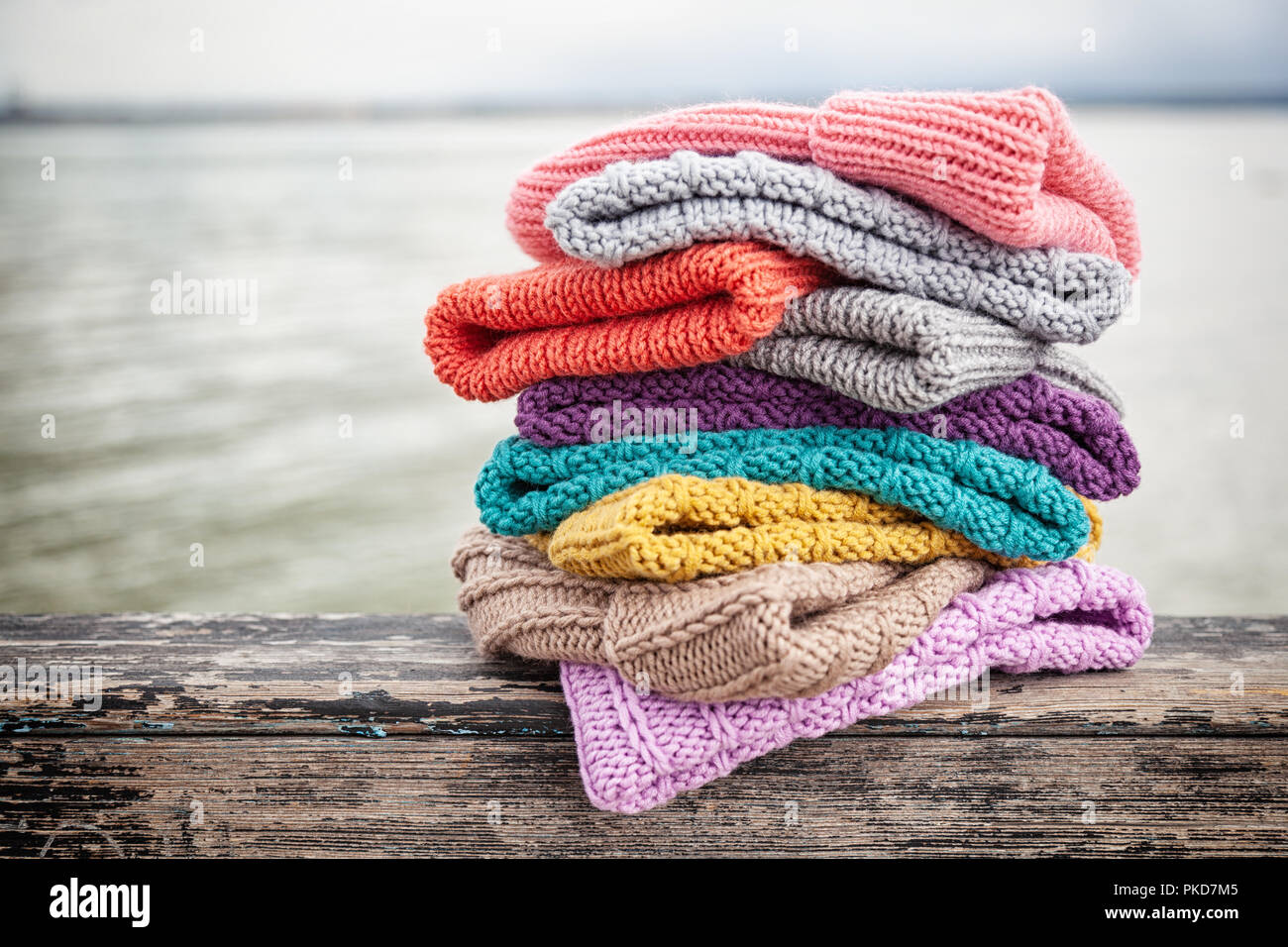 https://c8.alamy.com/comp/PKD7M5/beautiful-background-knitting-winter-blue-and-yellow-a-lot-hat-crochet-hook-handmade-close-up-of-knitted-hats-of-blue-yellow-pink-and-white-PKD7M5.jpg