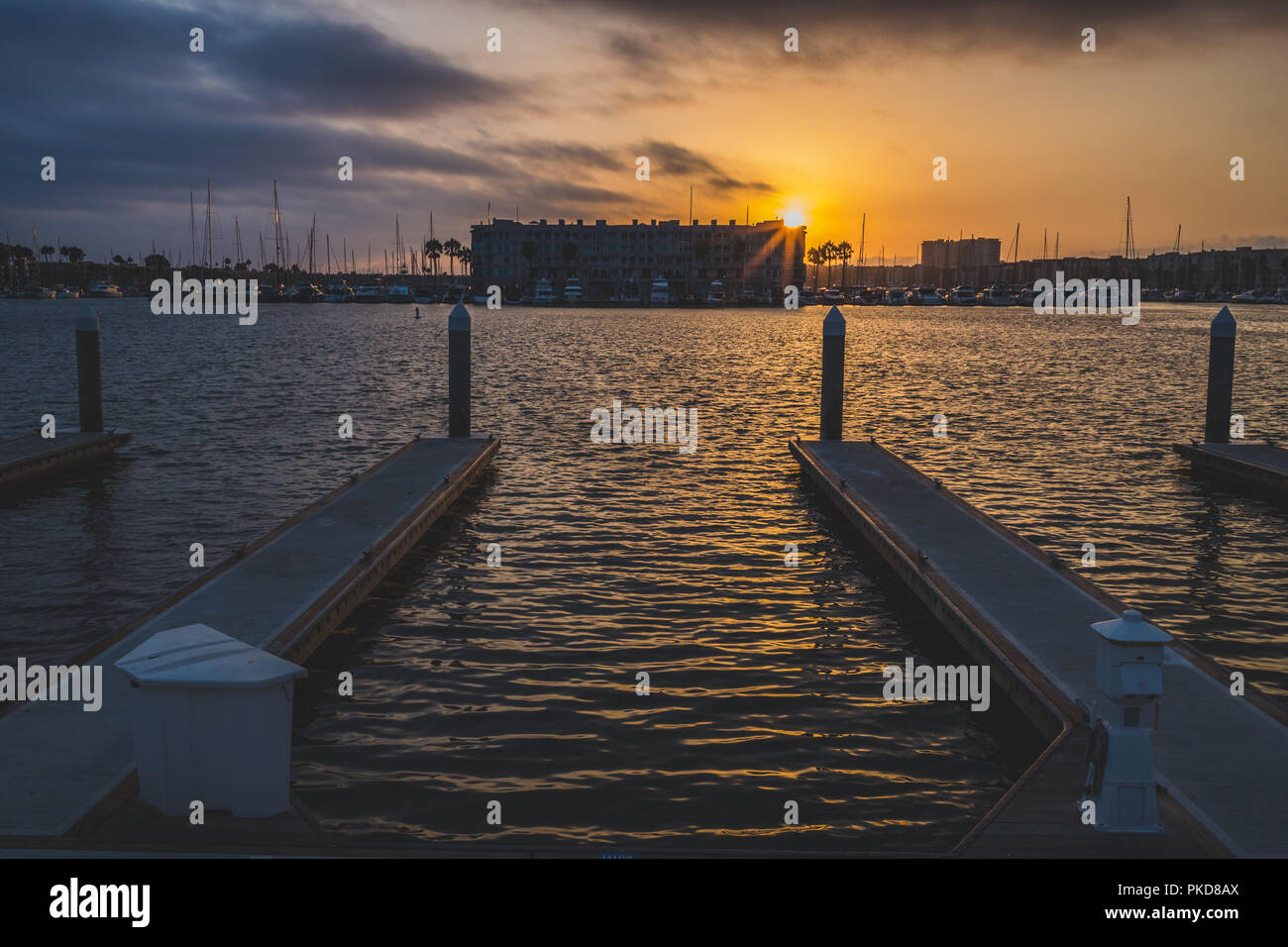 Dramatic clouds and colorful sky at sunset with calm water surrounding